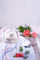 marshmallows in a glass stand on a blue fabric