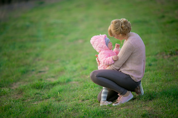 Fototapeta premium mom gently hugs the little daughter and soothes her after tears.