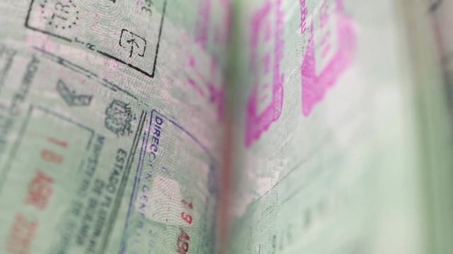 turning passport pages full of stamps