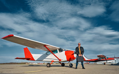 business man on the runway at the plane