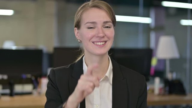 Portrait of Beautiful Young Businesswoman Pointing at Camera