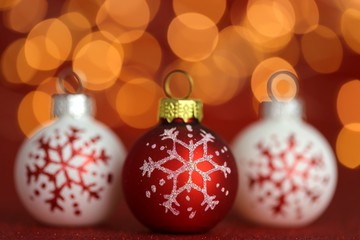 Christmas shiny wallpaper.Christmas festive background. christmas ball set with snowflake on red glitter background with yellow blurred bokeh.Winter holidays.