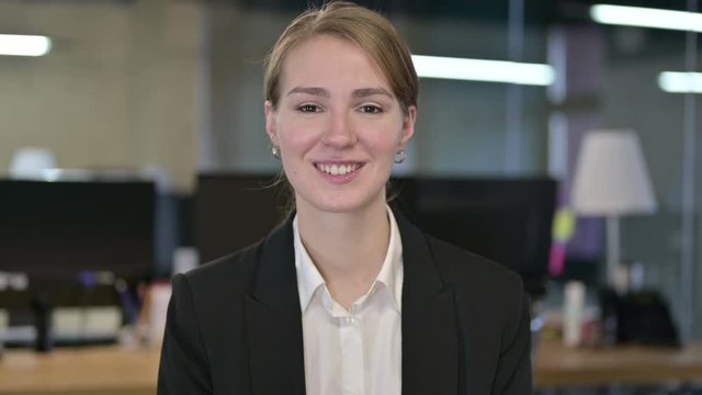 Portrait of Attractive Young Businesswoman Giving Flying Kiss