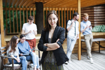 Portrait of an asian business woman over people background.