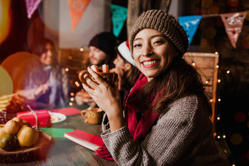 Navidad mexicana, Woman drinking Ponche Navideño celebrating a Posada in Christmas Mexico