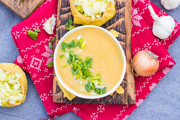 Peas soup with cabbage salad. Hot yellow creamy homemade soup with peas and green onion sprouts on winter Christmas or Xmas background. Vegan and vegetarian food. 