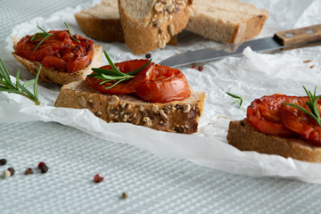 Delicious homemade bruschetta with whole grain bread, grilled tomatoes and fresh arugula....