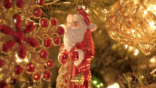 Santa Claus  shaped Decorstion hangs on a Christmas tree close steady view