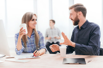 young employees discussing something during the coffee break.
