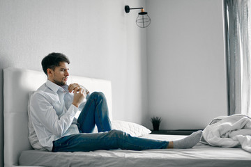young man sitting on sofa and watching tv