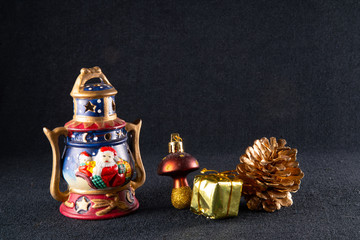 Pine cone, garland and other Christmas decoration, on a black background