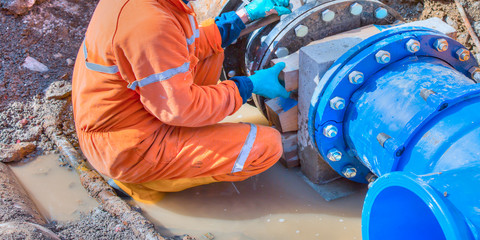 Worker man building big pipe- constructions