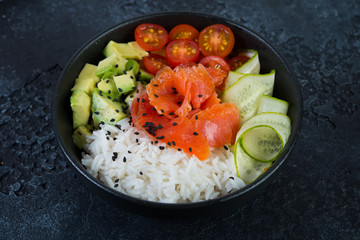 A popular Hawaiian dish, Poke in a plate of red fish, rice and vegetables.