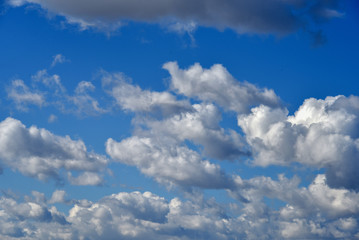 Naklejka na ściany i meble Clouds on a clear Sunny spring sky as a background