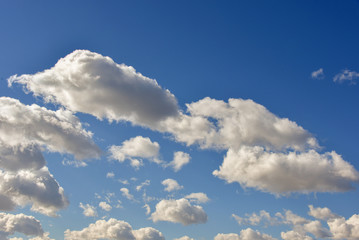 Naklejka na ściany i meble Clouds on a clear Sunny spring sky as a background