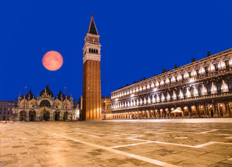 Naklejka premium Piazza San Marco with the Basilica of Saint Mark and the bell tower of St Mark's Campanile with full moon 
