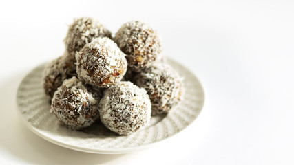 Energy balls on a white bowl on a white background