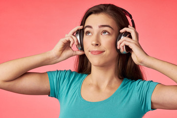 young woman listening to music with headphones