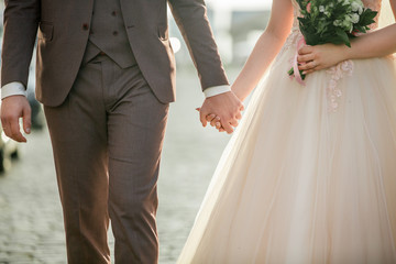 close up. bride and groom walking together.