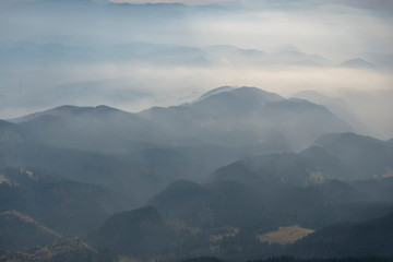 Fototapeta na wymiar Foggy layered mountain landscape in Piatra Craiului mountains