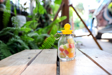Jelly jar Baby toy on a wooden table in the garden Blurred background