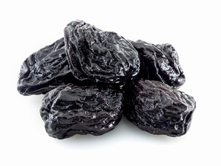 Juicy dried prunes on a white background