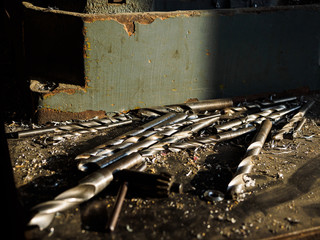 Some old rusty drills on a steel machine in the factory building