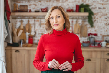 Attractive female standing in the middle of her kitchen