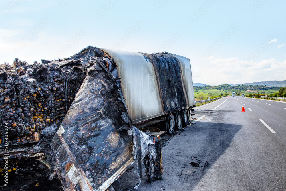 Wall mural truck burnt and abandoned along the road