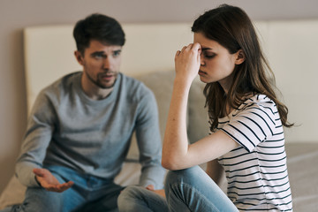 man and woman talking on cell phone