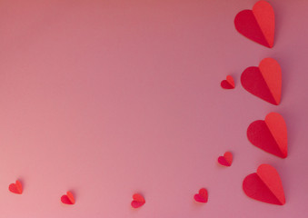 Hearts on a pink background. Valentin's Day, top view. Copy space. Flat lay. Greeting card.