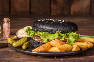 Tasty grilled homemade burger with beef, tomato, cheese, cucumber and lettuce