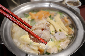 use chopsitck boiled sliced chicken  over shabu hot pot