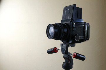 Old and vintage medium format film camera on a tripod