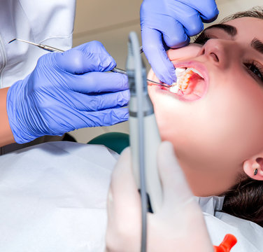Dentist and his assistant carrying out a thorough examination (real treatment)
