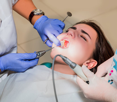 Dentist and his assistant carrying out a thorough examination (real treatment)