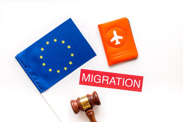 Migration to Europa concept. European flag near passport and judge hammer on white background top-down
