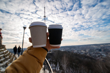 woman hand holding two coffee cup drink to go