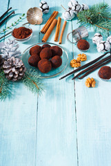 Christmas chocolate truffles and spices on shabby chic blue wood table