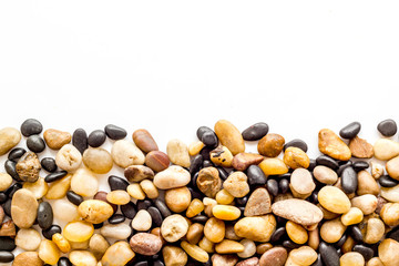 Sea stones background with white copy space top-down frame