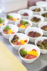 Kitchen work - sliced salman and fruit in cups