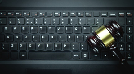 Judge gavel on laptop keyboard. Internet crime