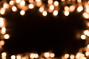 Blurry christmas lights. Christmas lights border. Christmas background with lights and free text space. Christmas lights on black background. New Year.