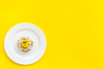 Cat's birthday concept. Pet feed with festive candle in shape of three on yellow background top-down copy space