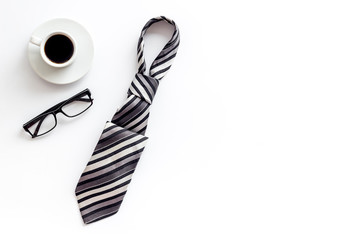 Father's day concept. Card with men's tie, glasses, coffee on white background top-down copy space