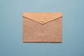 Brown mail envelope on blue flat lay background.