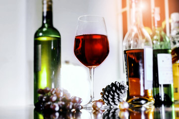 Soft focus red wine in glass on the bar, and hands of a bartender at bar  with glass whiskey drink,