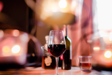 Soft focus red wine in glass on the bar, and hands of a bartender at bar  with glass whiskey drink,