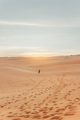 Girl standing in desert.