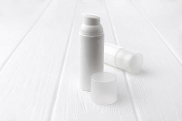 Jar of cosmetic cream on a white wooden background with copy space